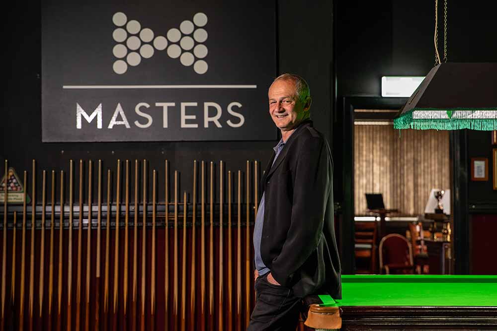 Man standing in front of a sign that reads Masters