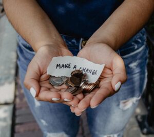 Hands outstretched with month and a make a change written on a piece of paper for Specialist Industry Support