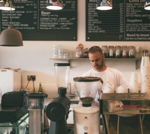 Barista making coffee in a cafe