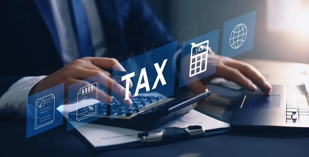 Businessman using the laptop to fill in the income tax online return form for payment. Financial research,government taxes and calculation tax return concept. Tax and Vat concept.